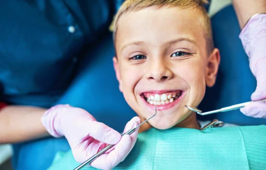 A young boy smiles at the dentist